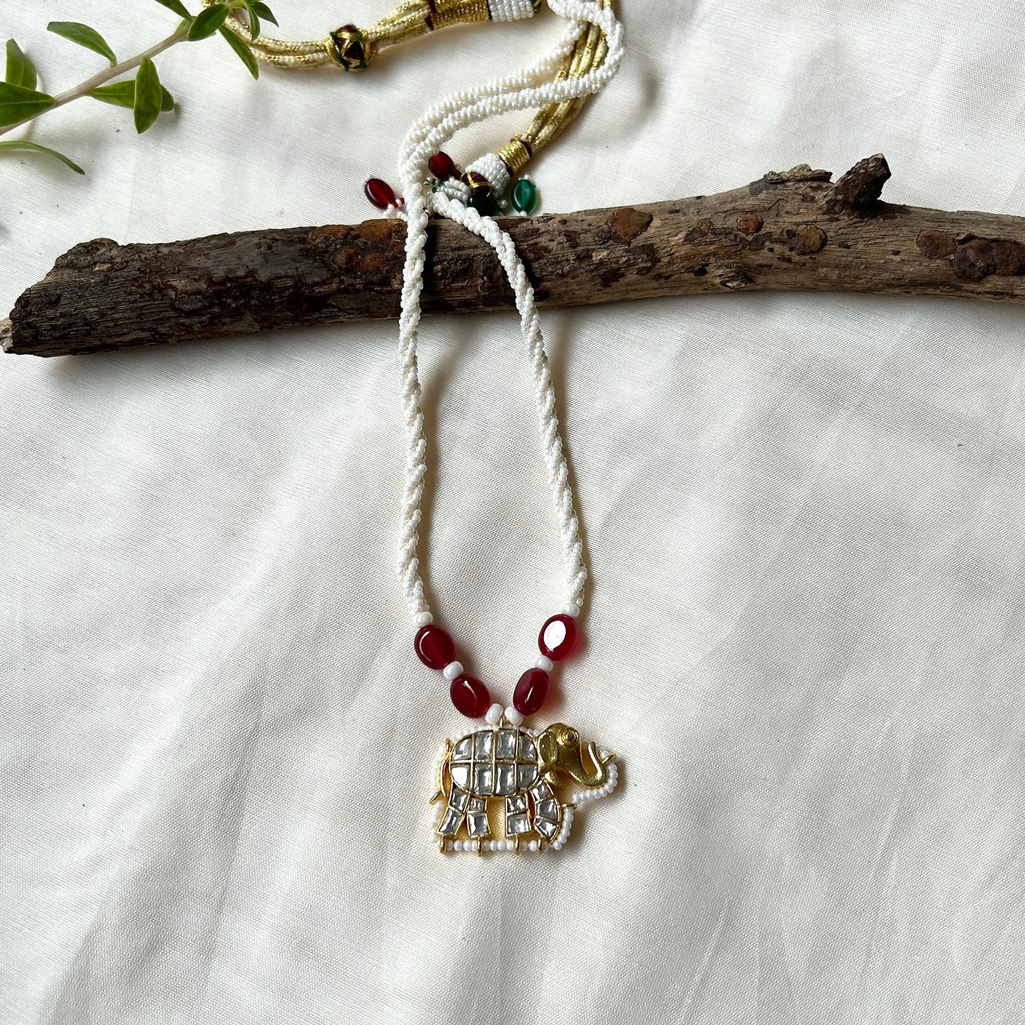 Rajsi Gajmukhta white kundan necklace with elephant pendant, ched pearls, and jade stones