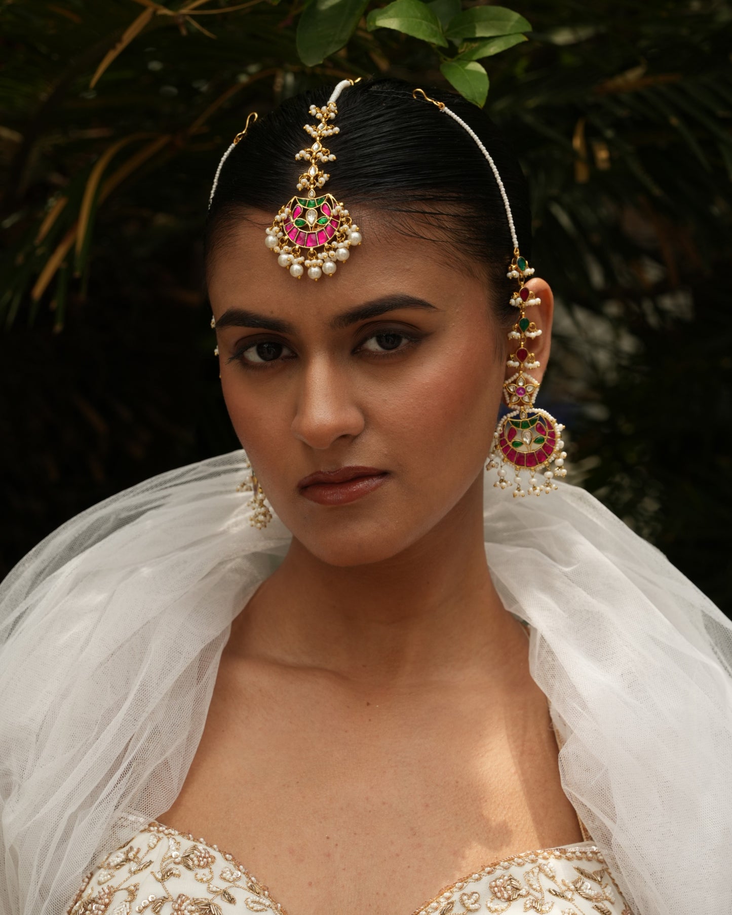 Woman wearing traditional jewelry with a blurred natural background