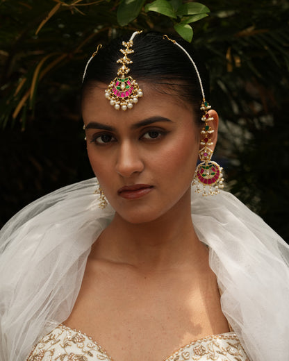Woman wearing traditional jewelry with a blurred natural background